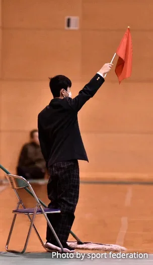 Photograph of a Flagman waving flags and signalling.