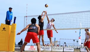 Photograph of beach volleyball players.