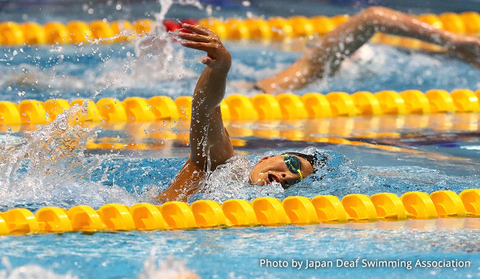 Photograph of a swimming athlete.